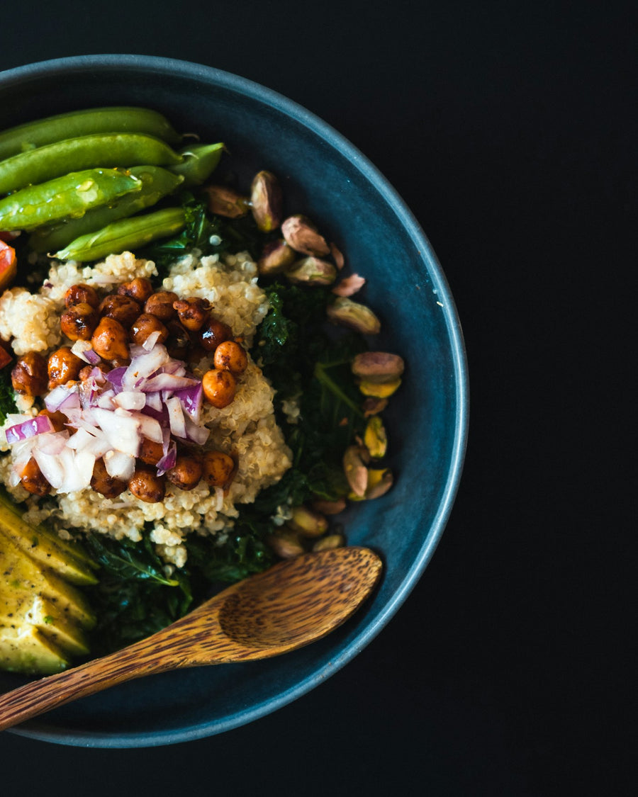 A salad bowl topped with pistachios